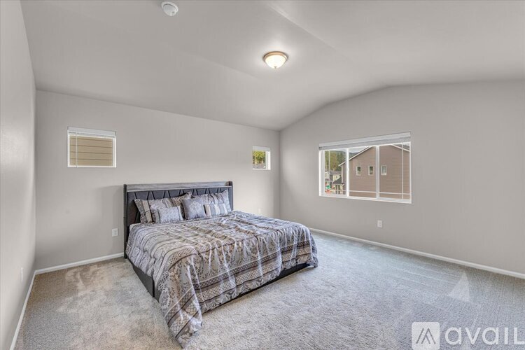 A bedroom with a bed and a window.