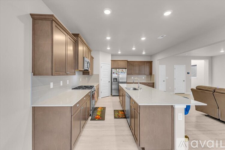 A modern kitchen with wooden cabinets and a white countertop.