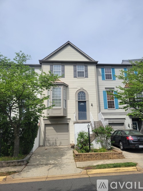 A two-story house with a grey and blue exterior.