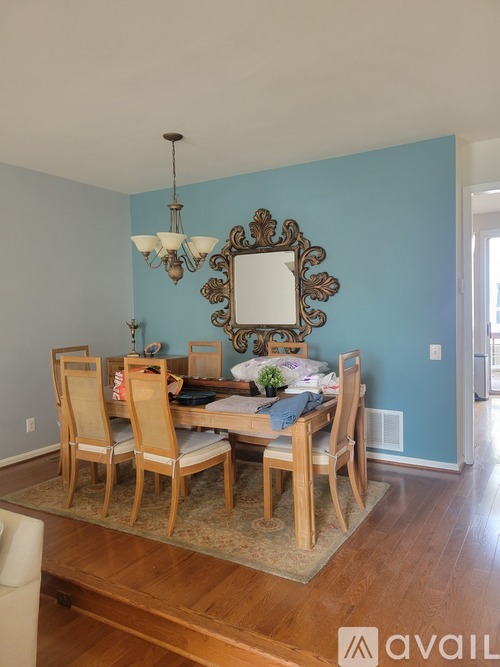 A dining room with a table set for six.