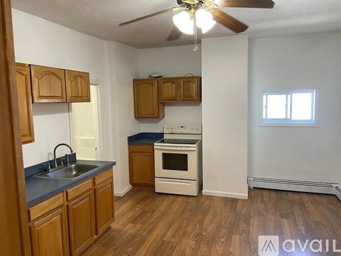 A kitchen with wooden cabinets and a white oven.