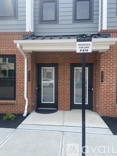 A building entrance with a sign that says "Reserved for Unit P-618".