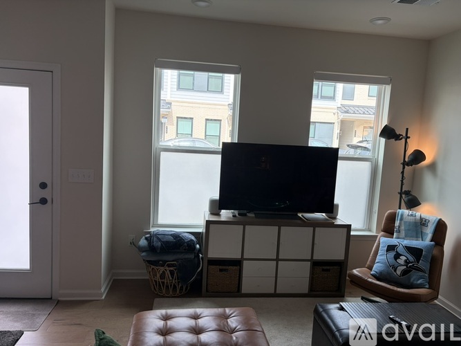 A living room with a television and a chair.