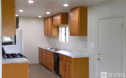 A kitchen with wooden cabinets and a white countertop.