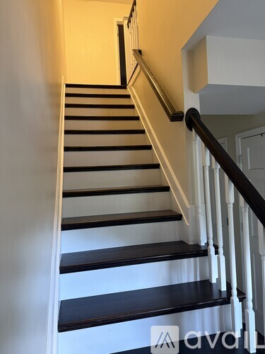 A staircase with black and white steps.
