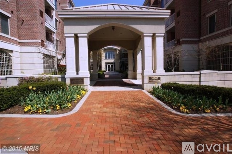 A brick pathway leads to a building entrance.