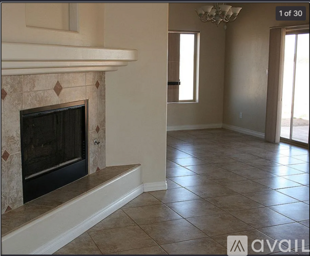 A living room with a fireplace and tiled flooring.