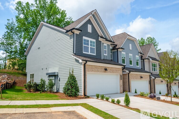 A large house with a grey exterior and a white garage door.
