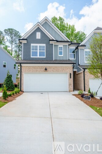 A two-story house with a garage is for sale.