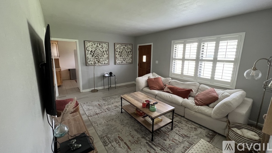A living room with a white couch and a coffee table.