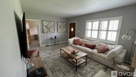 A living room with a white couch and a coffee table.