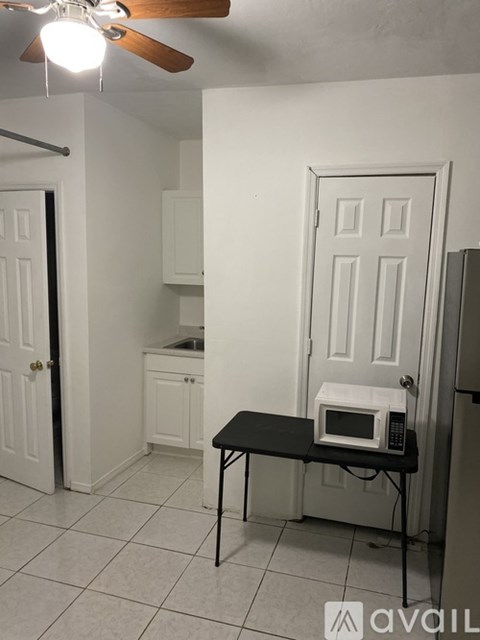 A kitchen with a table and a microwave on it.