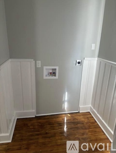 A room with wood floors and white walls.