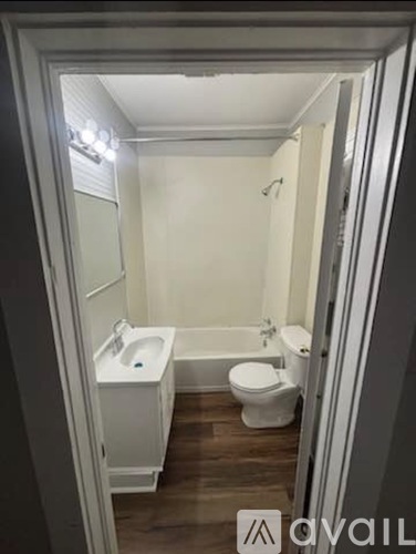 A small bathroom with a toilet, sink, and bathtub.
