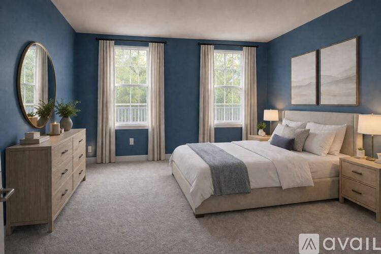 A bedroom with a large bed, a dresser, and a mirror.