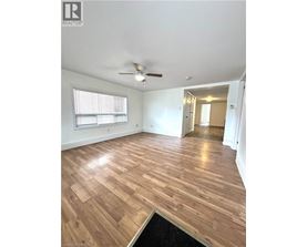 A room with wooden flooring and a ceiling fan.