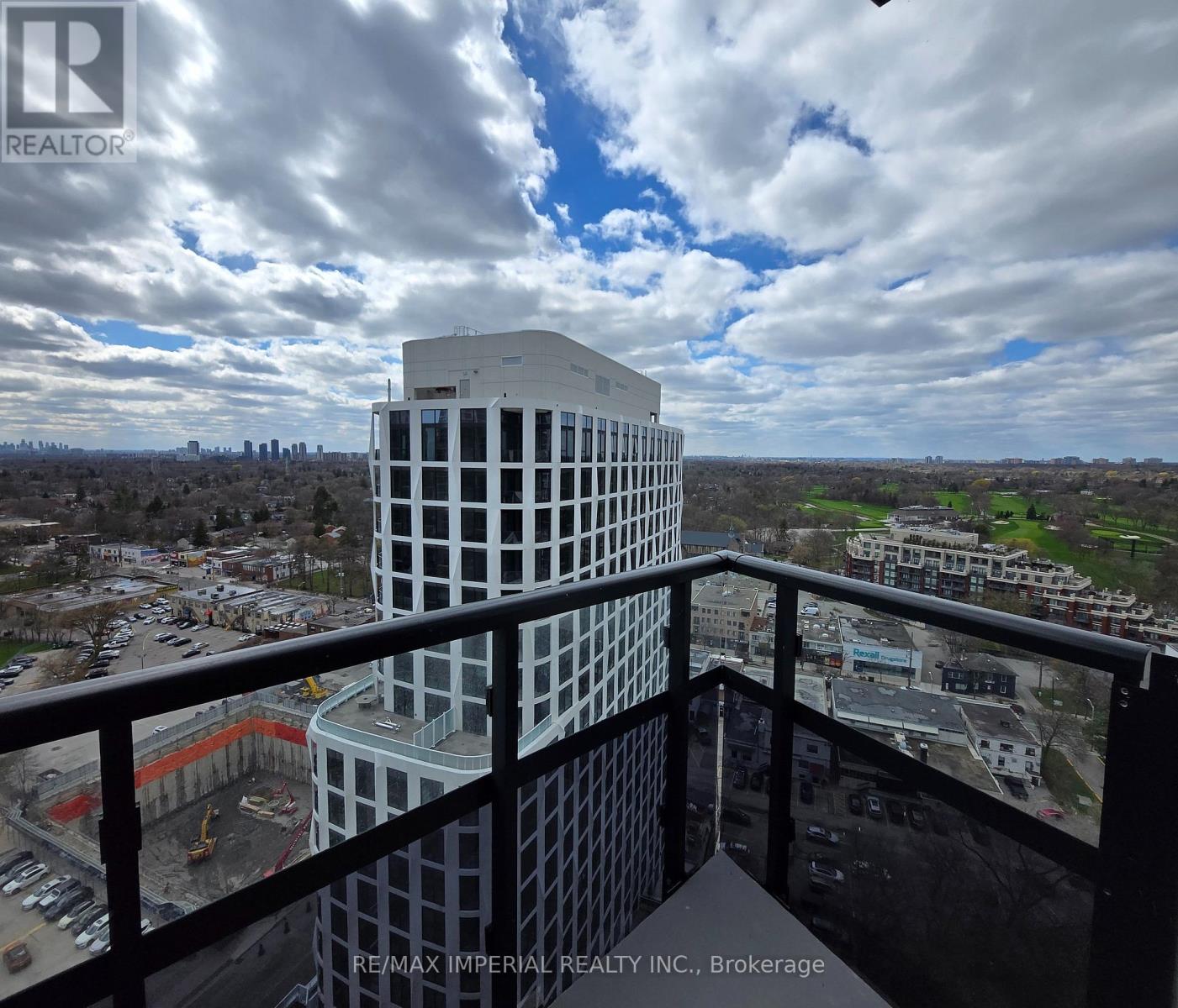 A view from a balcony of a building with the sign RE/MAX IMPERIAL REALTY INC. BROKERAGE.
