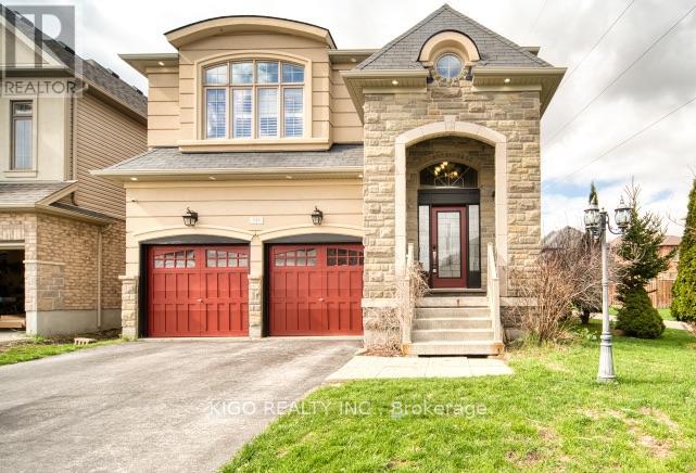 A house with a stone facade and two red garage doors.