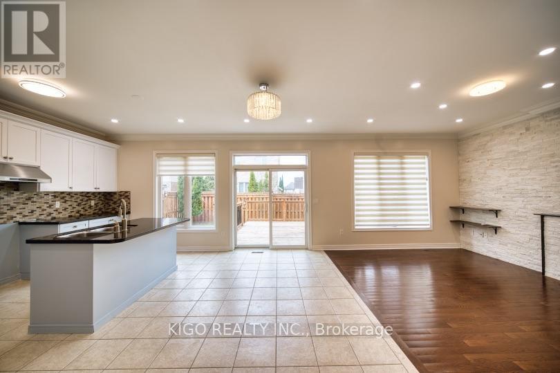 A spacious kitchen with a countertop and a dining area with a table and chairs.