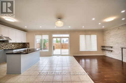 A spacious kitchen with a countertop and a dining area with a table and chairs.