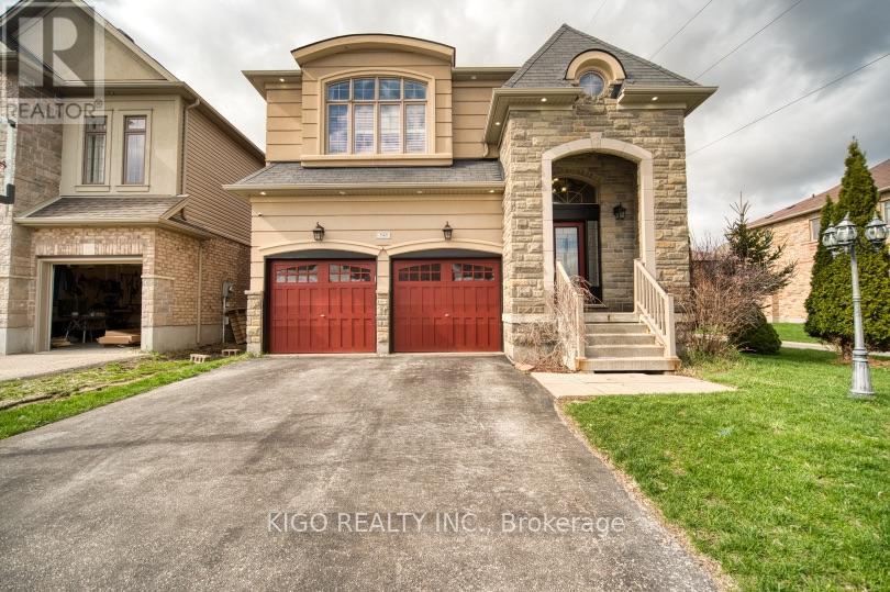 A house with a stone archway entrance and two red garage doors.