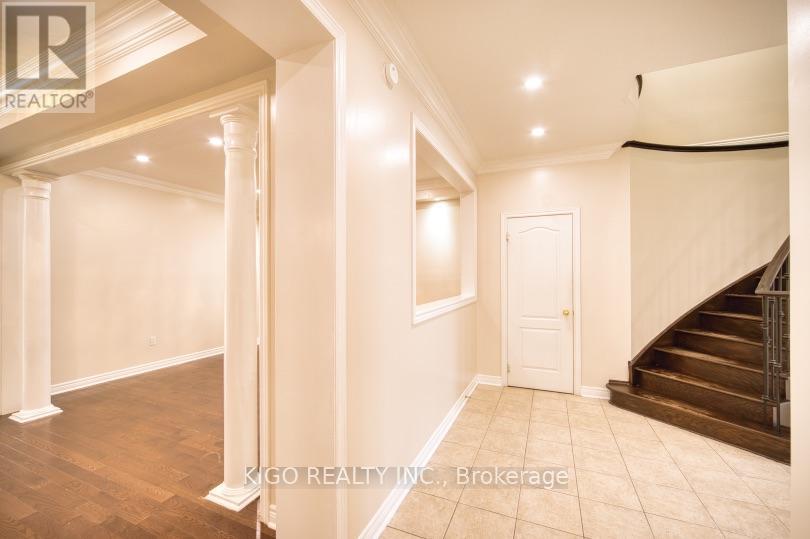 A spacious room with a staircase leading to the upper floor.