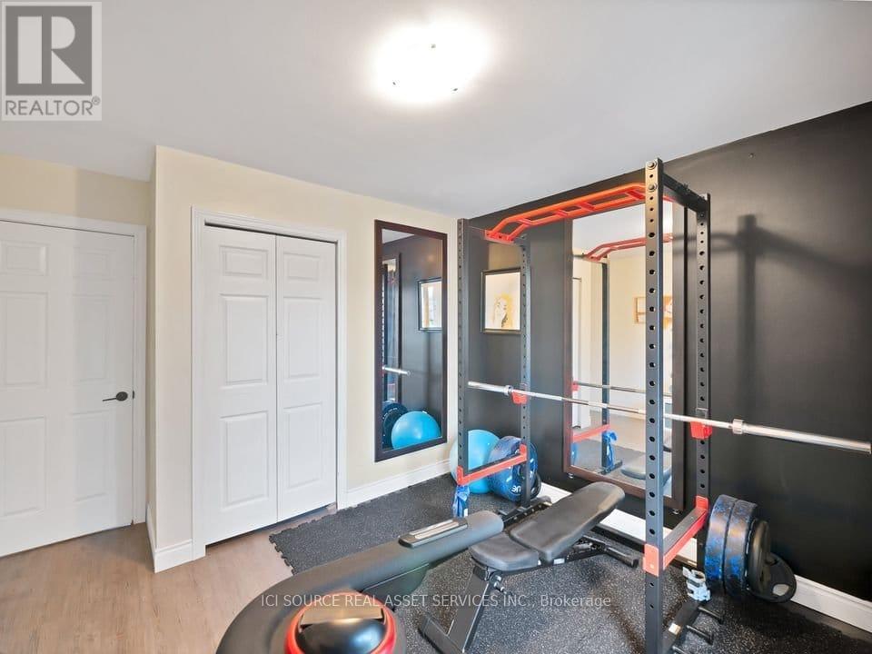 A home gym with a squat rack, weights, and exercise balls.