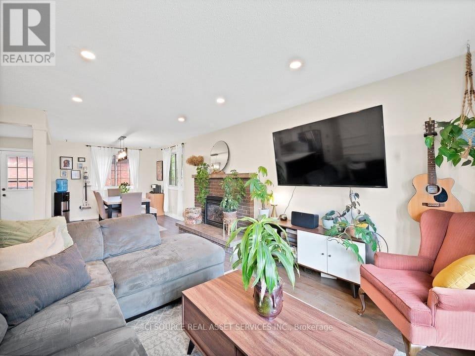 A living room with a grey couch and a pink couch.