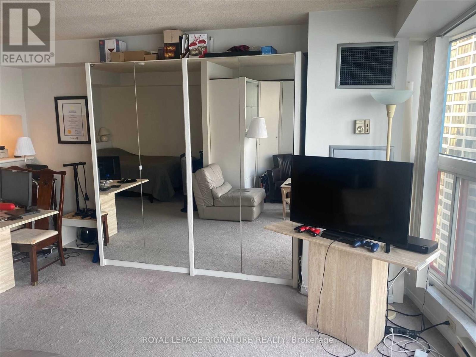 A living room with a television set on a stand.