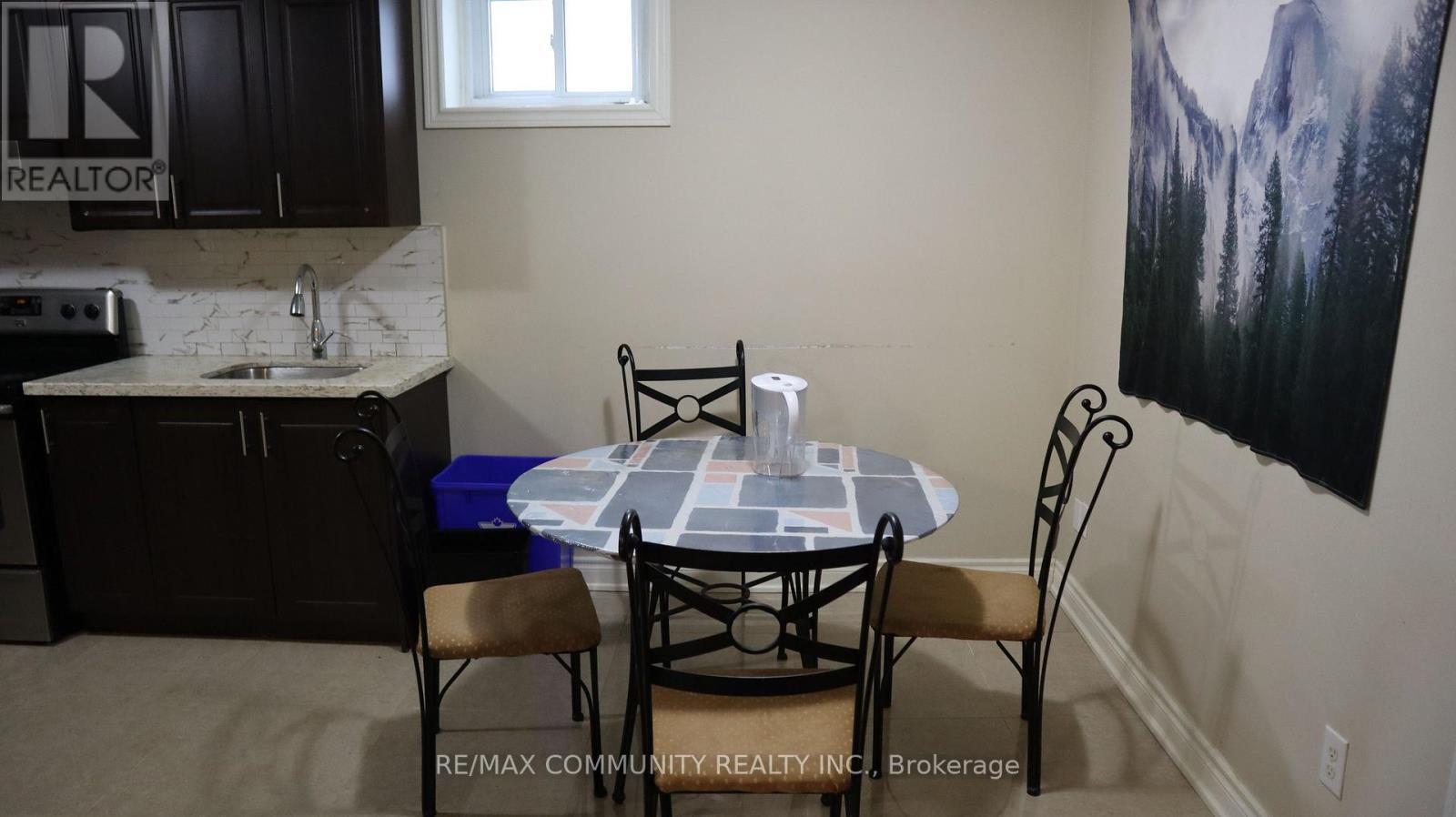 A dining room with a table and chairs.
