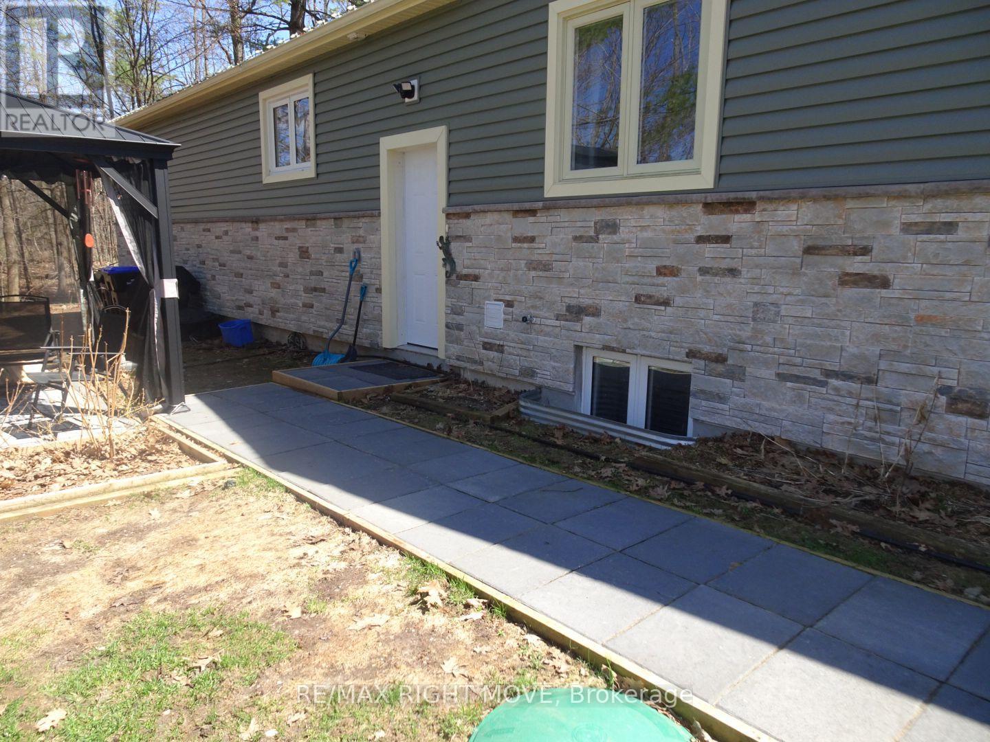 A house with a grey siding and a white door.