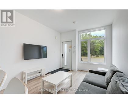 A living room with a flat screen TV mounted on the wall.