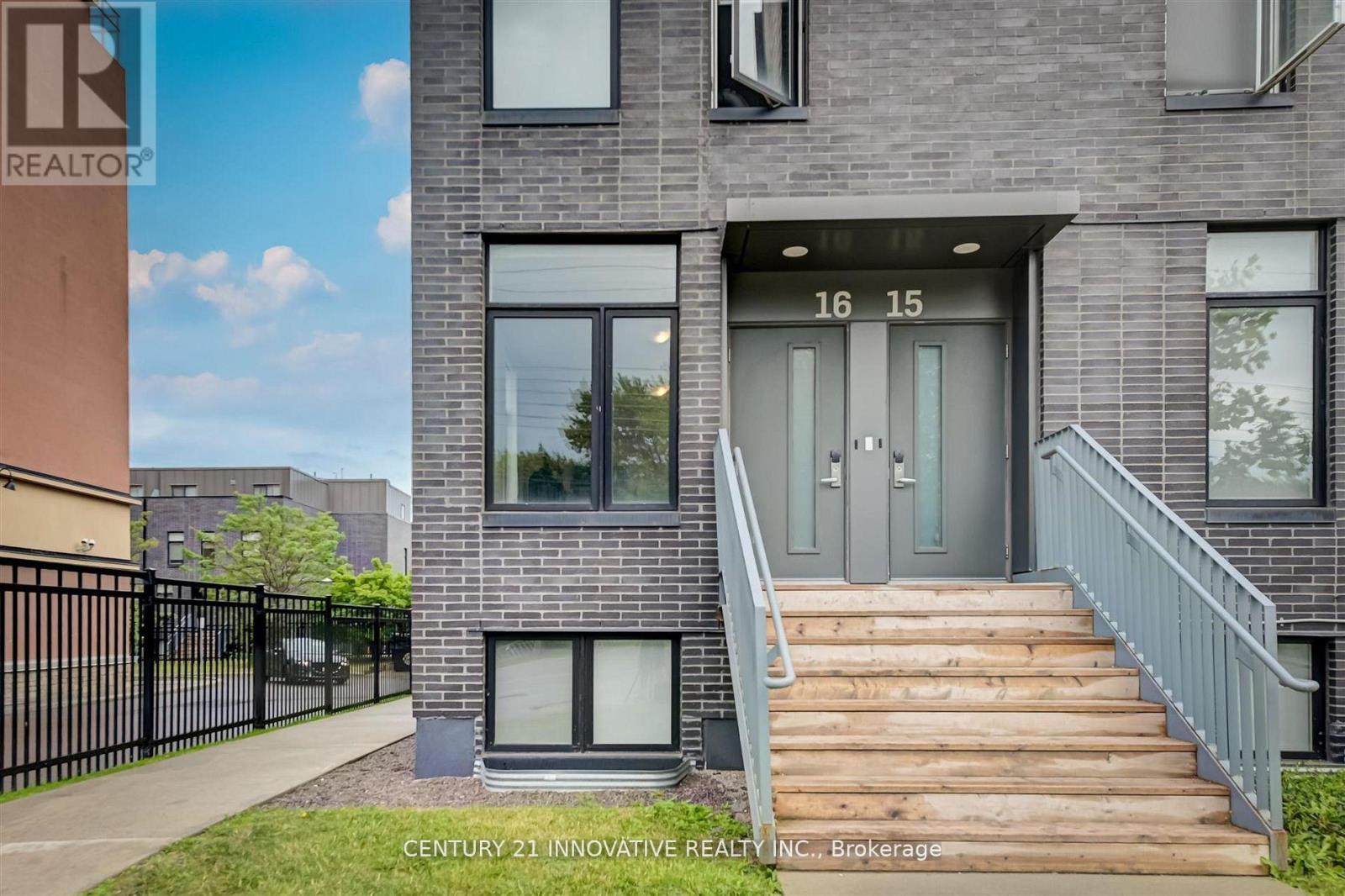 A modern building with the number 16 and 15 on the door.