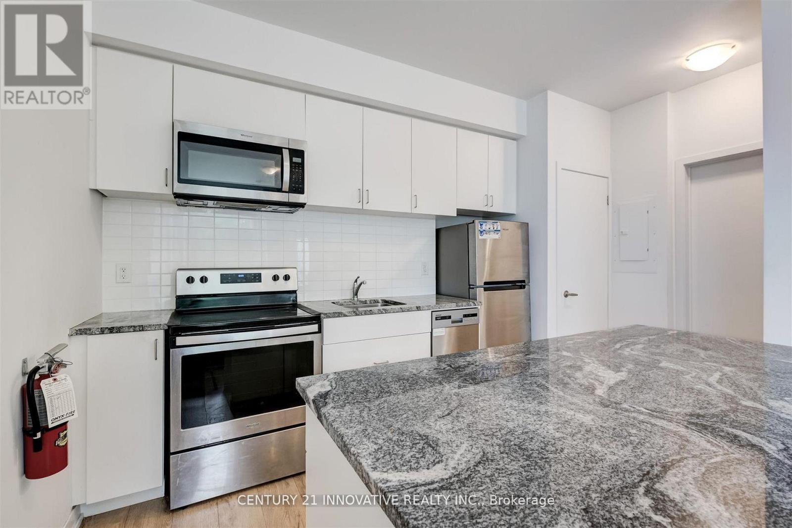 A kitchen with granite countertops and stainless steel appliances.