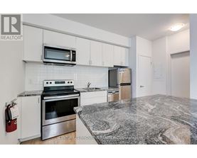 A kitchen with granite countertops and stainless steel appliances.
