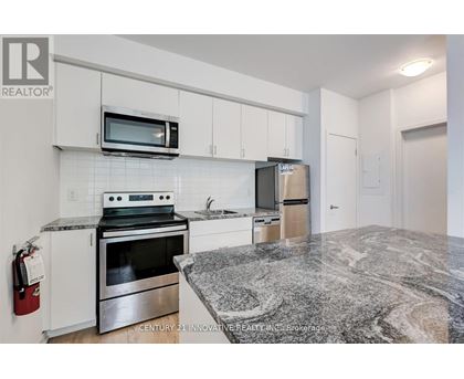 A kitchen with granite countertops and stainless steel appliances.