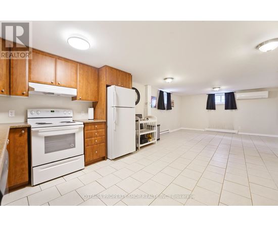 A kitchen with white appliances and wooden cabinets.