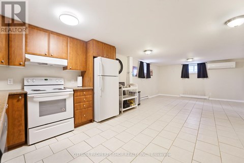 A kitchen with white appliances and wooden cabinets.