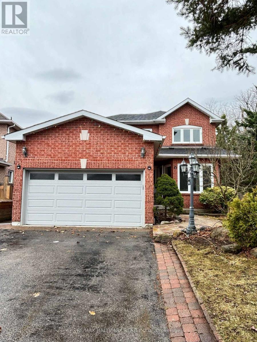 A red brick house with a white garage door.