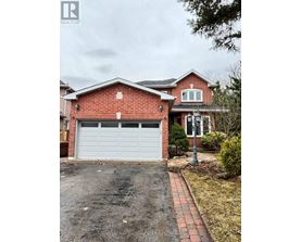 A red brick house with a white garage door.