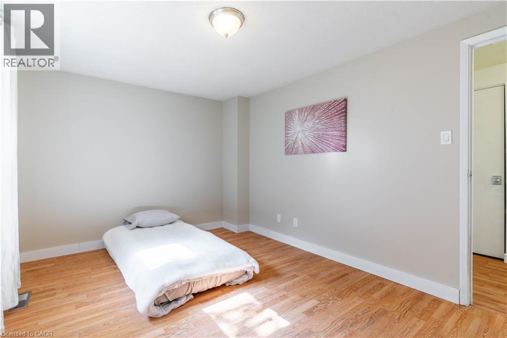 A bedroom with a bed and a painting on the wall.
