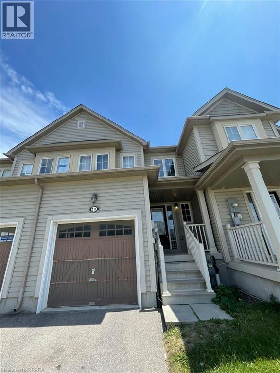 A two-story house with a garage is for sale.