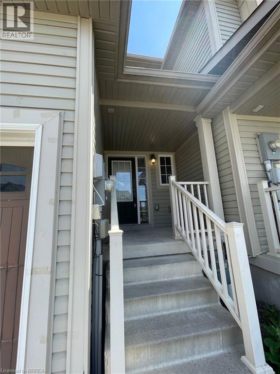 A house with a staircase leading to the front door.