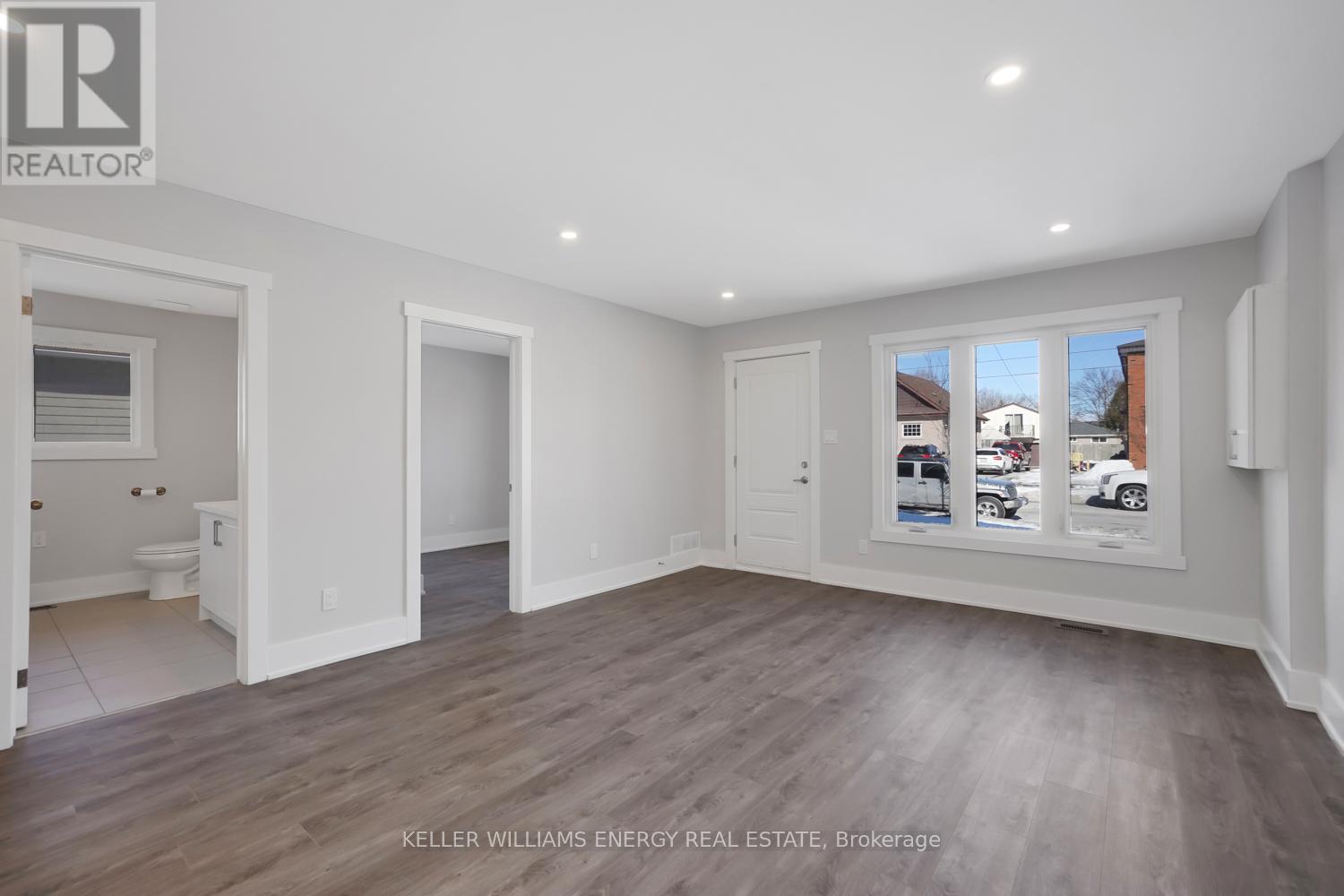 A realtor's office with a brokerage sign on the wall.