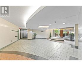 A spacious lobby with a tiled floor and a ceiling with a curved design.