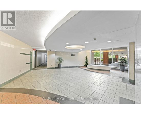 A spacious lobby with a tiled floor and a ceiling with a curved design.