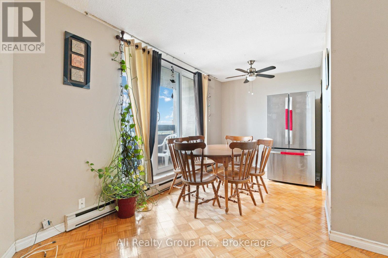 A dining room with a table and chairs.