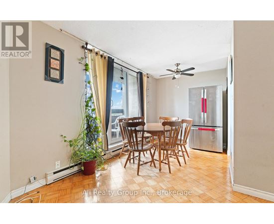 A dining room with a table and chairs.