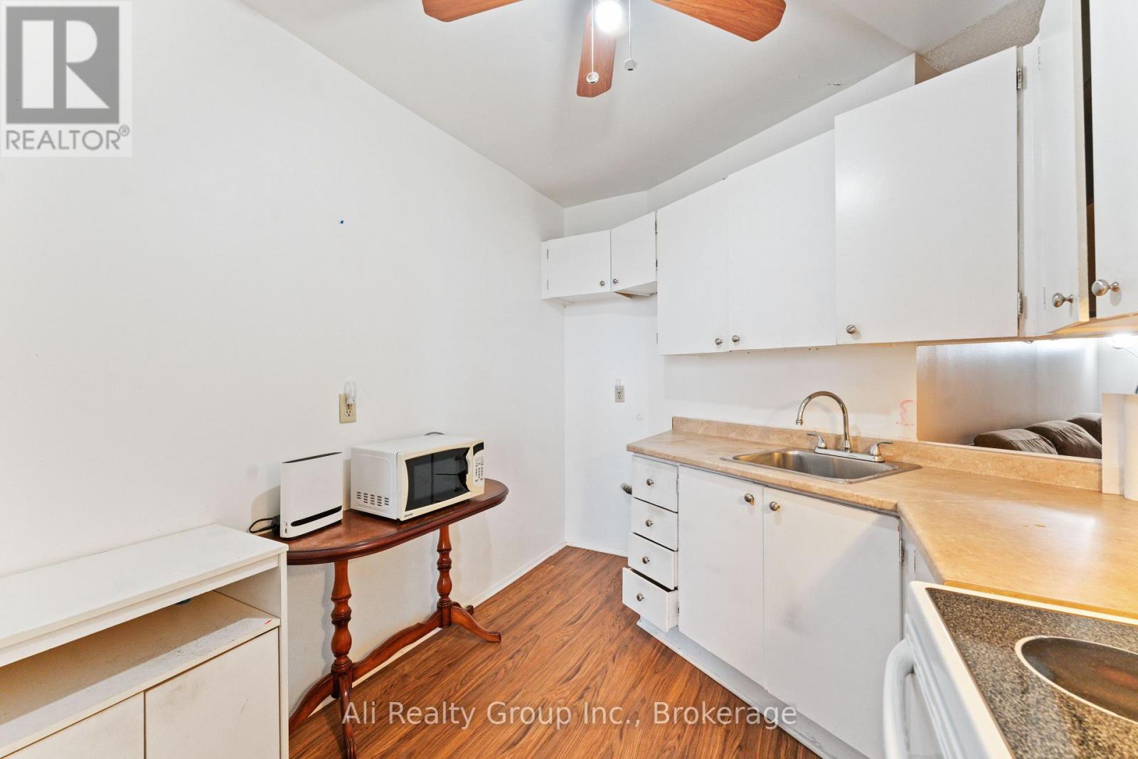 A kitchen with white cabinets and a wooden table.