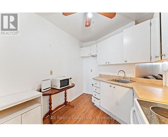 A kitchen with white cabinets and a wooden table.